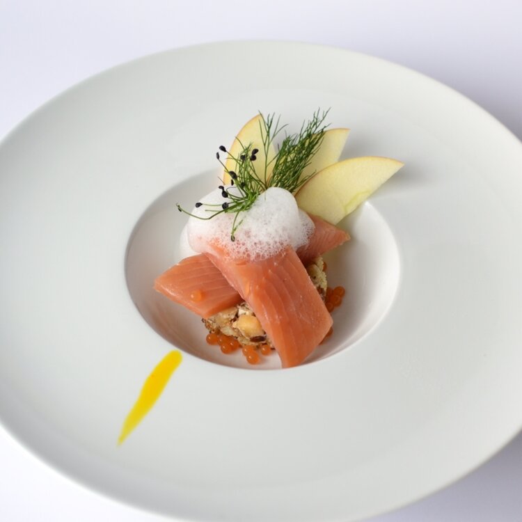 Marinated salmon trout with citrus on a diced apple bed